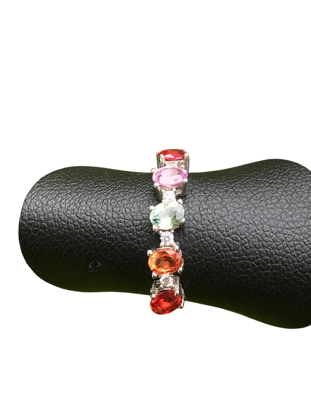 Multicolored gemstone ring on a black jewelry display