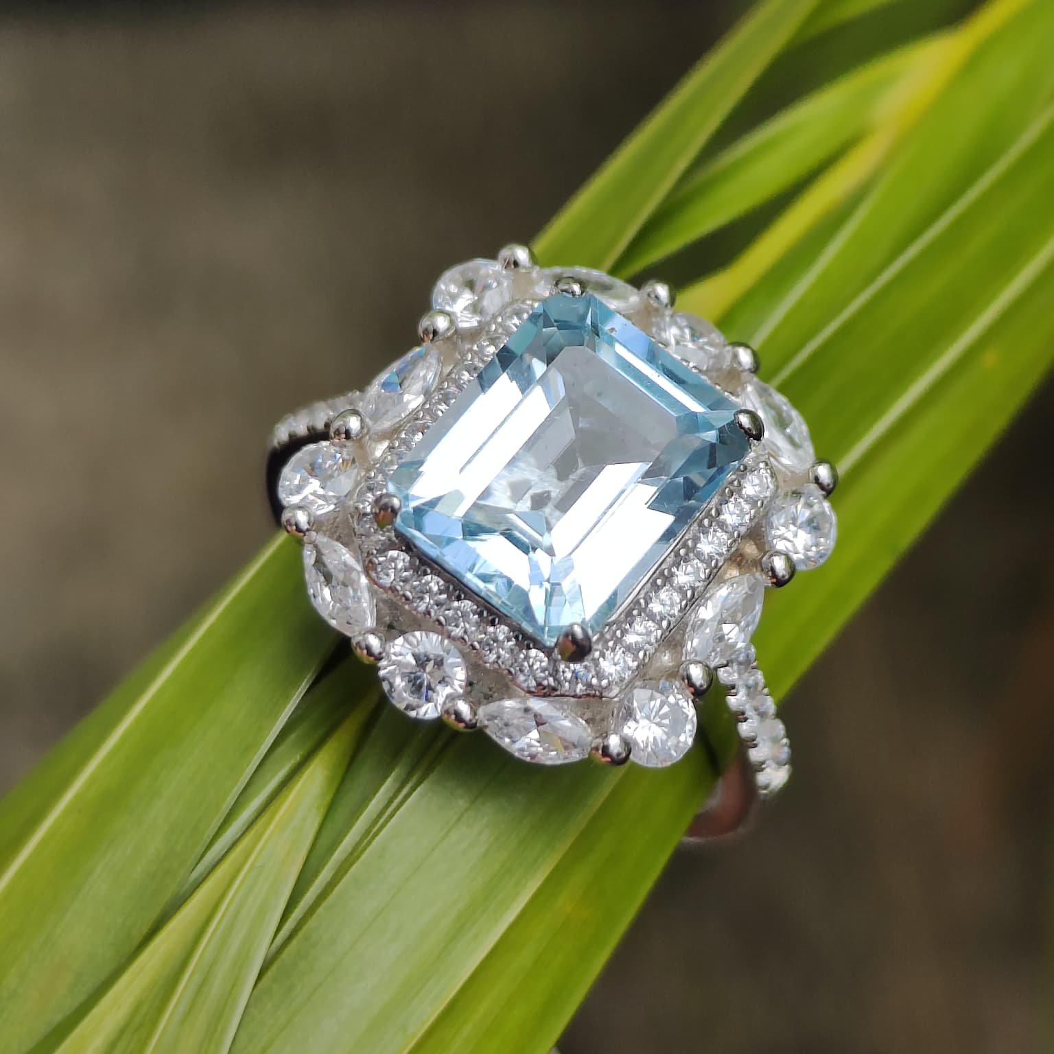 Iceberg Brilliance: Natural Sky Blue Topaz Emerald-Cut Ring with Marquise Halo in 925 Silver