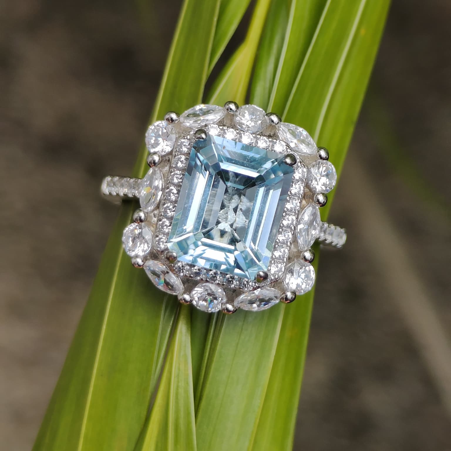 Iceberg Brilliance: Natural Sky Blue Topaz Emerald-Cut Ring with Marquise Halo in 925 Silver