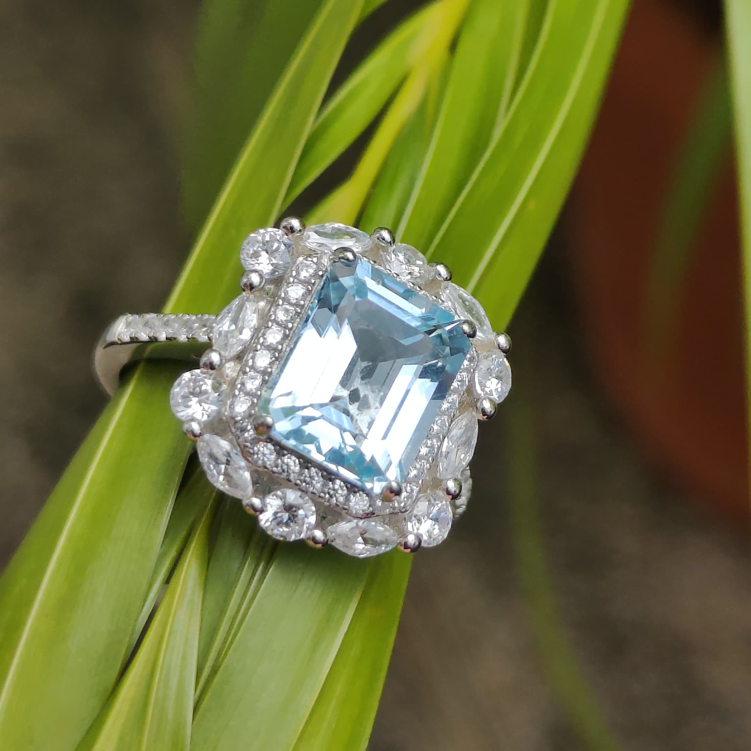 Iceberg Brilliance: Natural Sky Blue Topaz Emerald-Cut Ring with Marquise Halo in 925 Silver