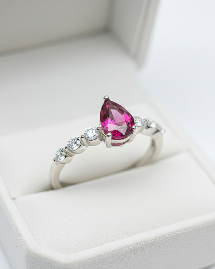 Ring with a pink gemstone in a white box