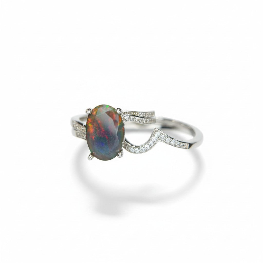 Silver ring with an opal stone on a white background