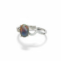 Silver ring with an opal stone on a white background