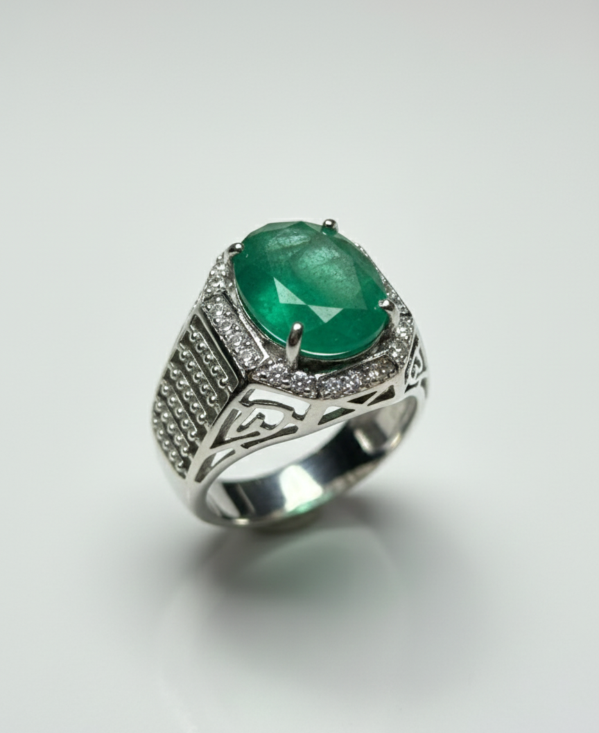 Silver ring with a green gemstone on a white background