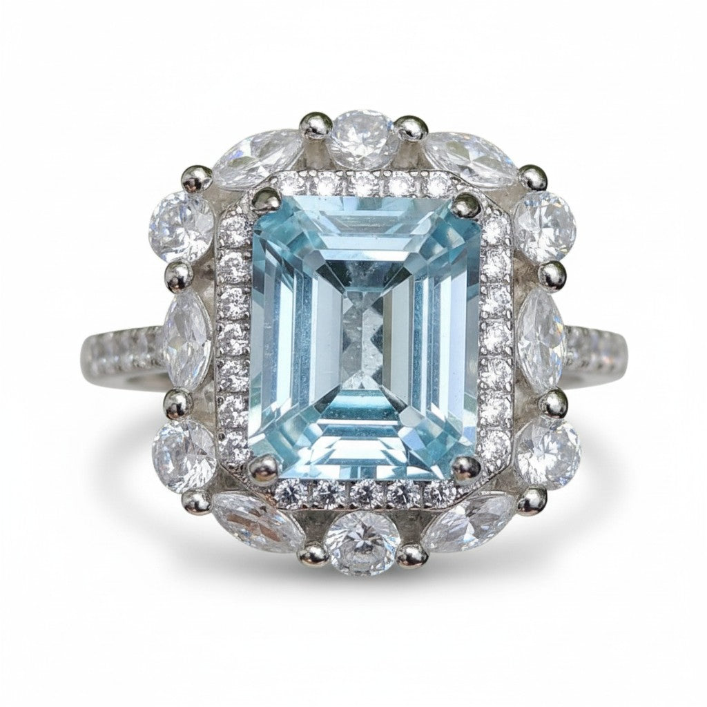 Iceberg Brilliance: Natural Sky Blue Topaz Emerald-Cut Ring with Marquise Halo in 925 Silver