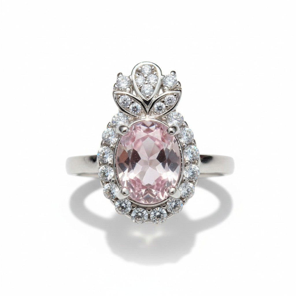 Silver ring with a pink gemstone on a white background