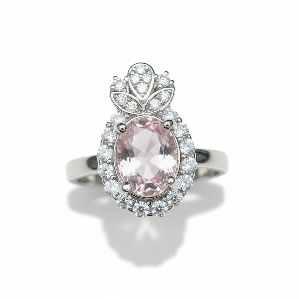 Ring with pink gemstone and cz diamond accents on a white background