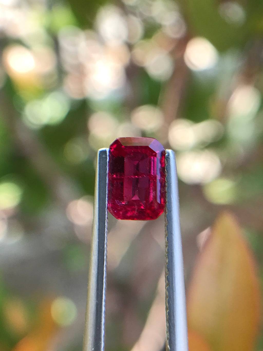 Shiza Gems 1.00 ct emerald cut vivid red pigeon blood ruby, unheated, CGRL certified, Mozambique origin.