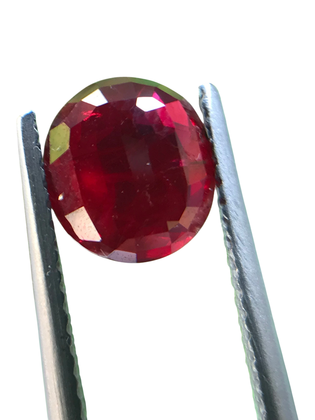 Shiza Gems 2.04 ct round cut vivid red unheated natural ruby gemstone held by tweezers.