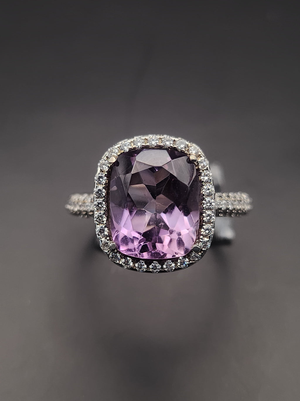 Shiza Gems natural cushion-cut amethyst ring with CZ halo in sterling silver. Soft lavender-purple gemstone with sparkling accents.
