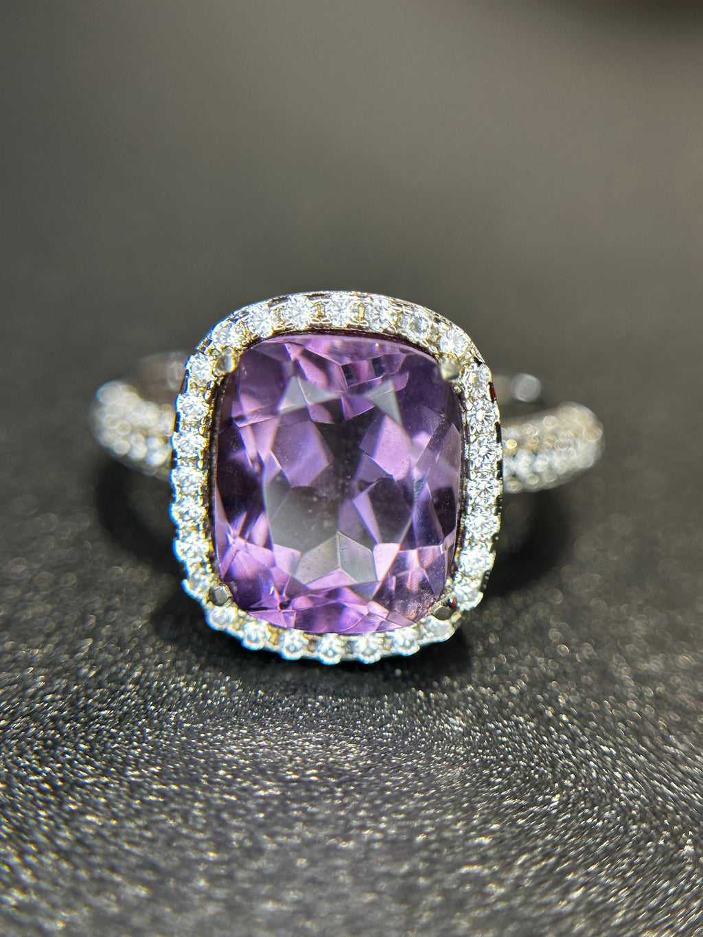 Shiza Gems natural cushion-cut amethyst ring with CZ halo in sterling silver. Soft lavender-purple gemstone with sparkling accents.