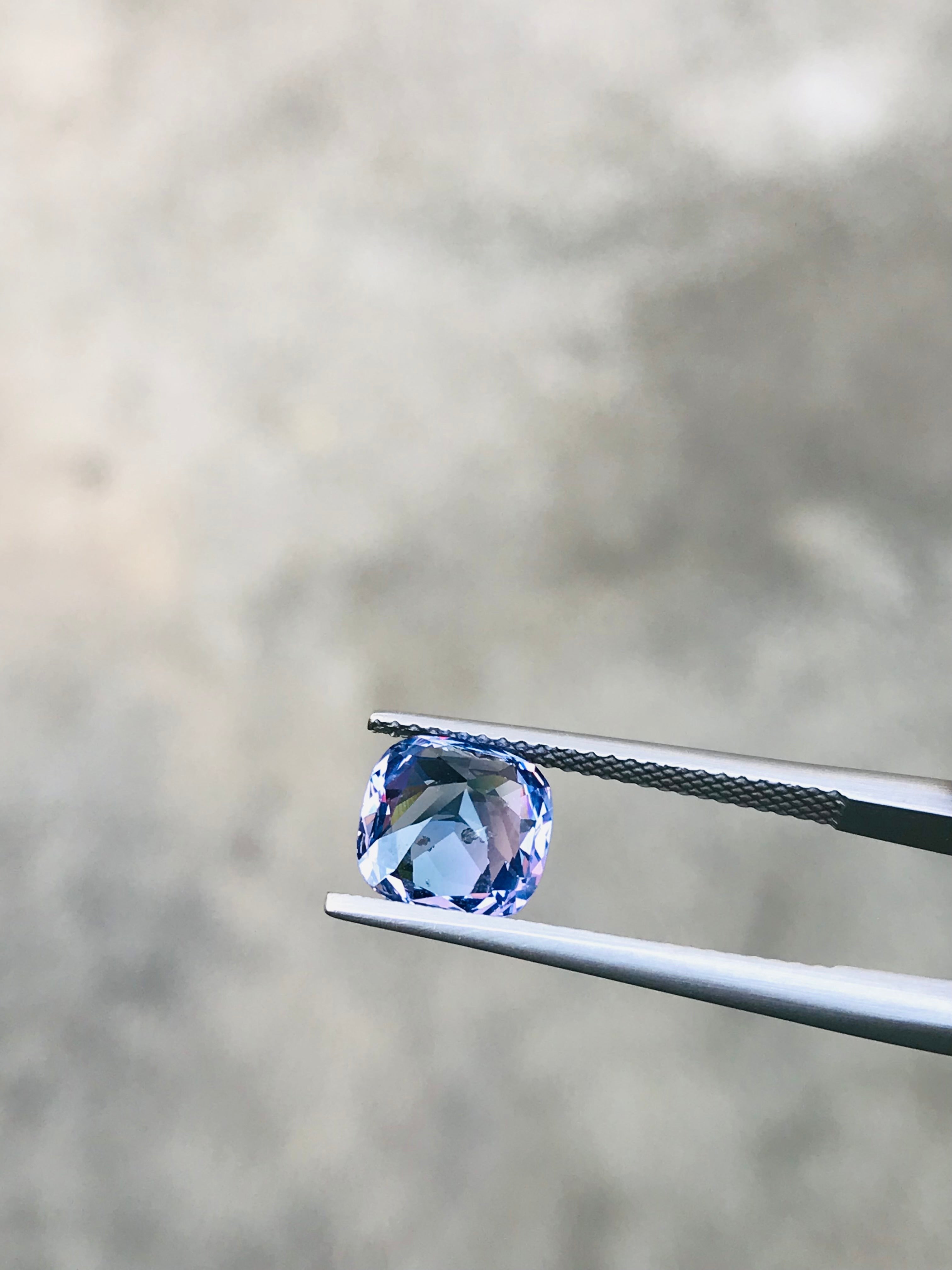 Shiza Gems 2.70 ct cushion cut bi-color spinel gemstone, teal-blue to lighter tones, faceted for brilliance.