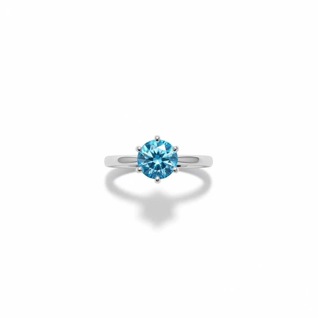 Shiza Gems blue moissanite solitaire ring, round brilliant cut, set in polished sterling silver with a 4-prong setting.
