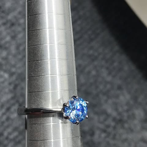 Shiza Gems blue moissanite solitaire ring, round brilliant cut, set in sterling silver with a 4-prong setting.
