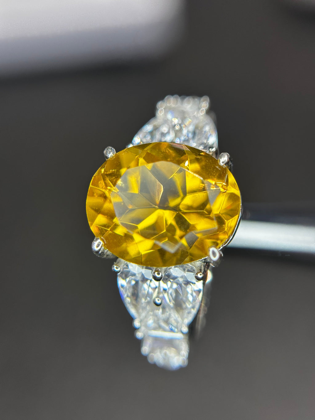 Shiza Gems large oval golden yellow citrine ring with pear-shaped cubic zirconia accents and full pavé band in sterling silver.