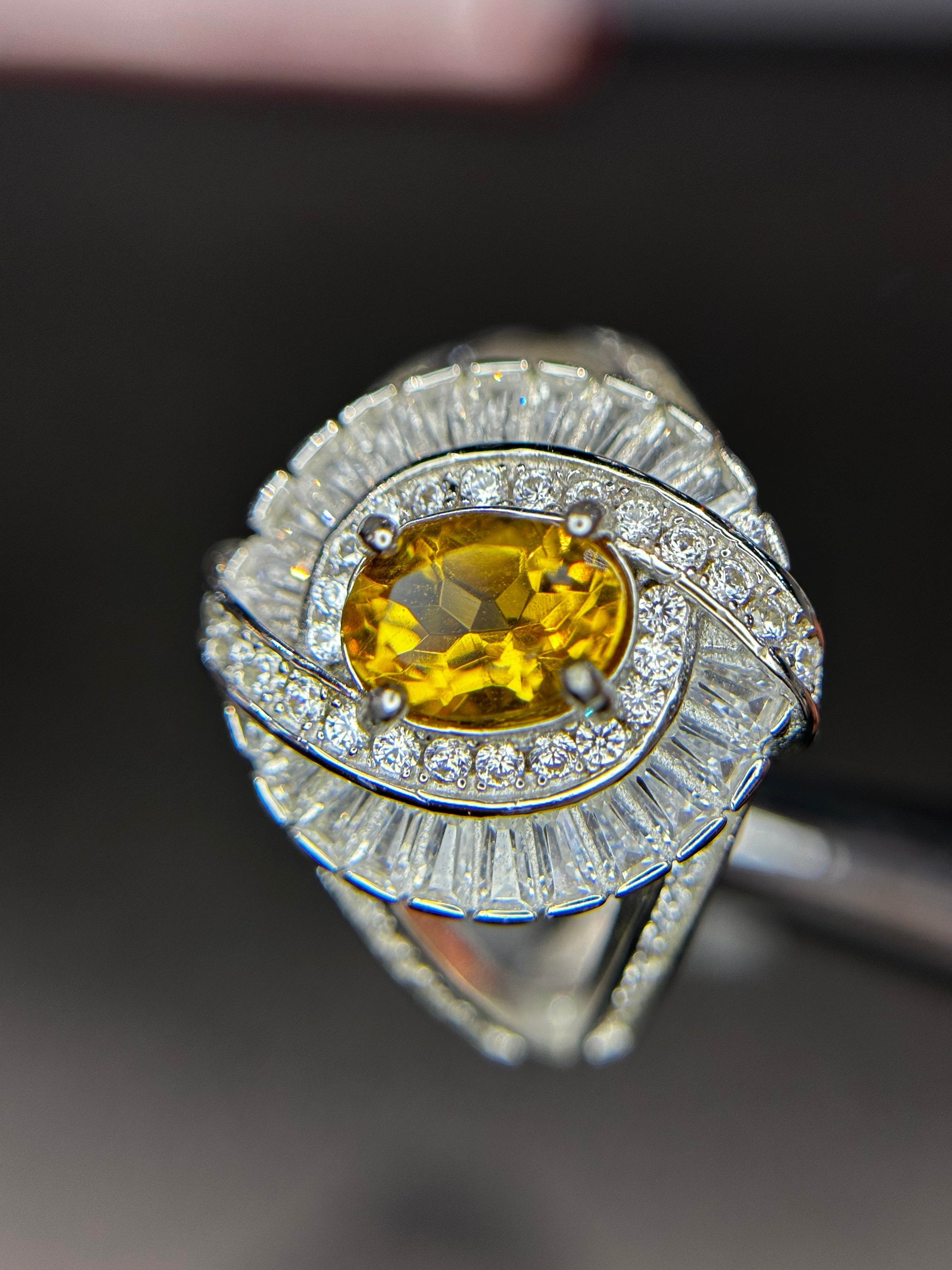 Shiza Gems large oval golden yellow citrine ring with double halo of cubic zirconia and baguette accents in sterling silver.