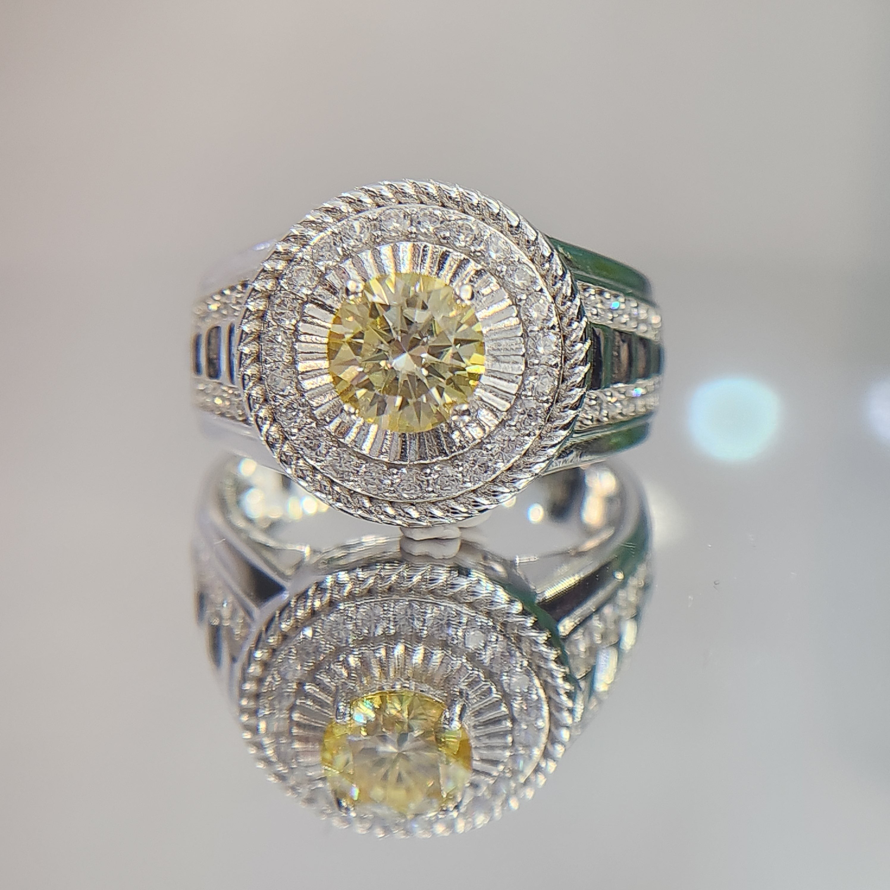 Shiza Gems men's sterling silver ring with round golden yellow moissanite, pavé halo, and green accents.