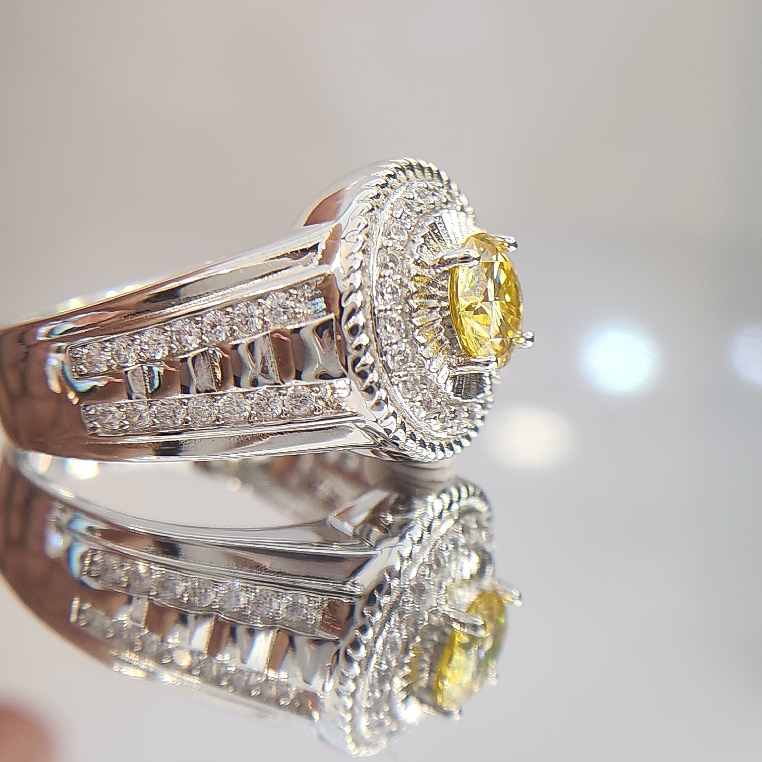 Shiza Gems men's sterling silver ring with round golden yellow moissanite, pavé halo, and green accents.