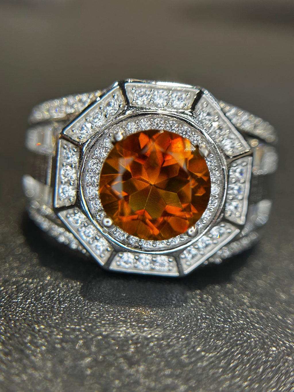 Shiza Gems men's ring with large oval golden-orange citrine center stone, surrounded by pave CZ accents in sterling silver.