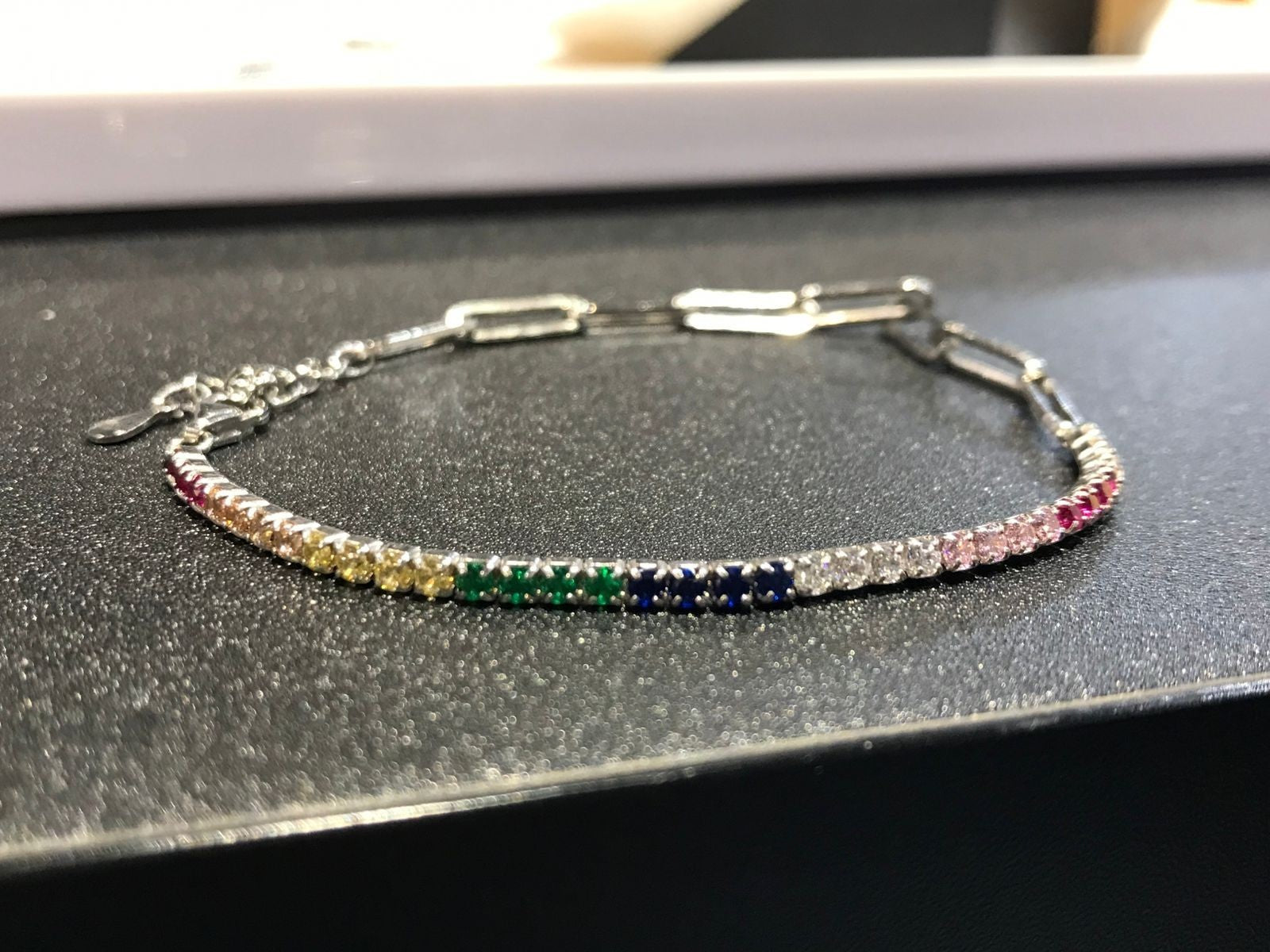 Shiza Gems multi color CZ tennis bracelet in sterling silver with rainbow gemstone style stones.