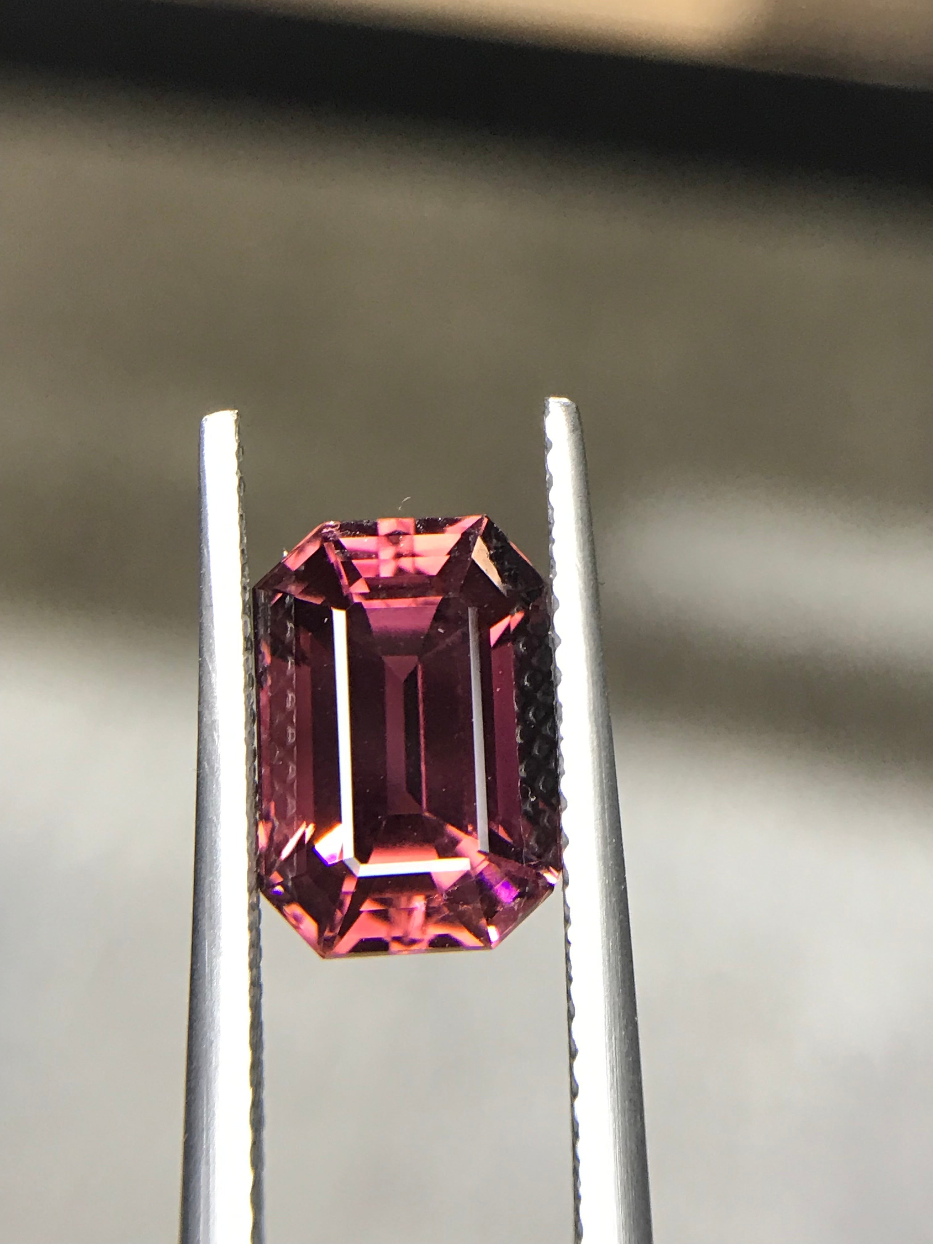 Shiza Gems 3.6 ct emerald-cut vivid pink tourmaline gemstone with step faceting and magenta undertones.