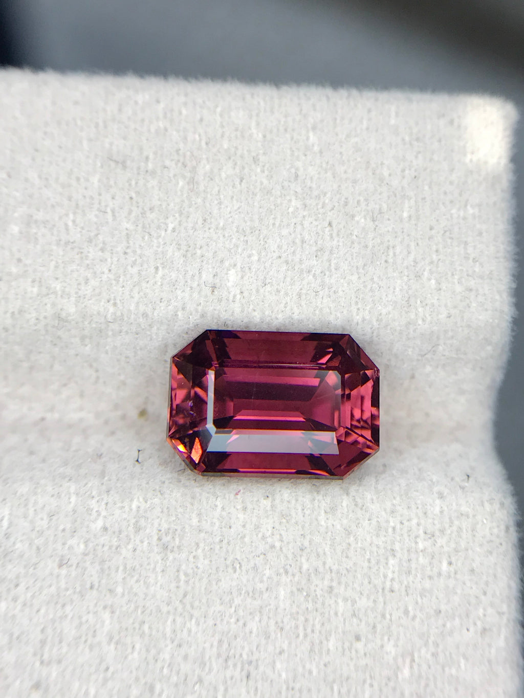 Shiza Gems 3.6 ct natural emerald-cut pink tourmaline gemstone with vivid magenta hue and step faceting.