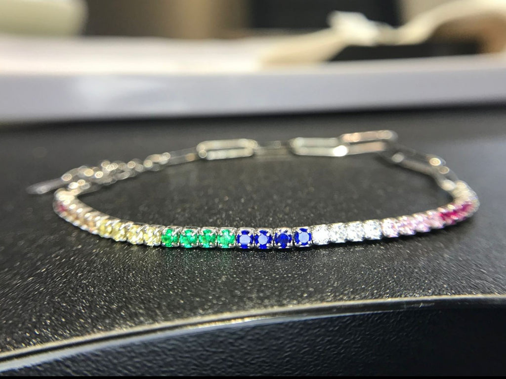 Shiza Gems rainbow multi color CZ tennis bracelet in sterling silver with yellow, green, blue, pink, and clear stones.