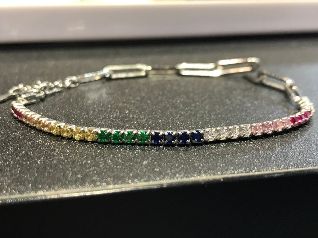 Shiza Gems rainbow multi color CZ tennis bracelet in sterling silver with clear, yellow, green, blue, pink, and red stones.