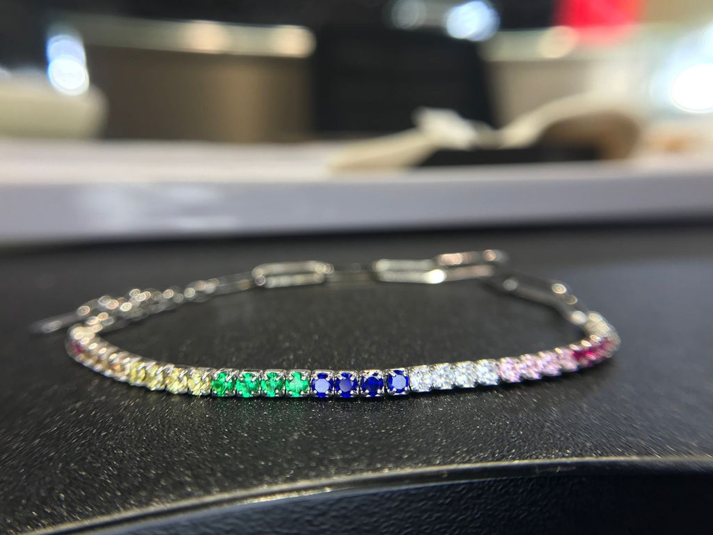 Shiza Gems rainbow multi color CZ tennis bracelet in sterling silver with clear, yellow, green, blue, pink, and red stones.