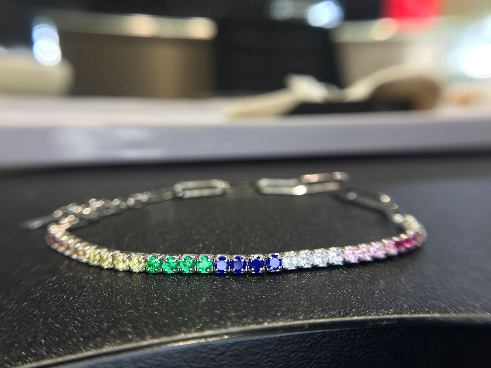Shiza Gems rainbow multi color CZ tennis bracelet in sterling silver with clear, yellow, green, blue, pink, and red stones.