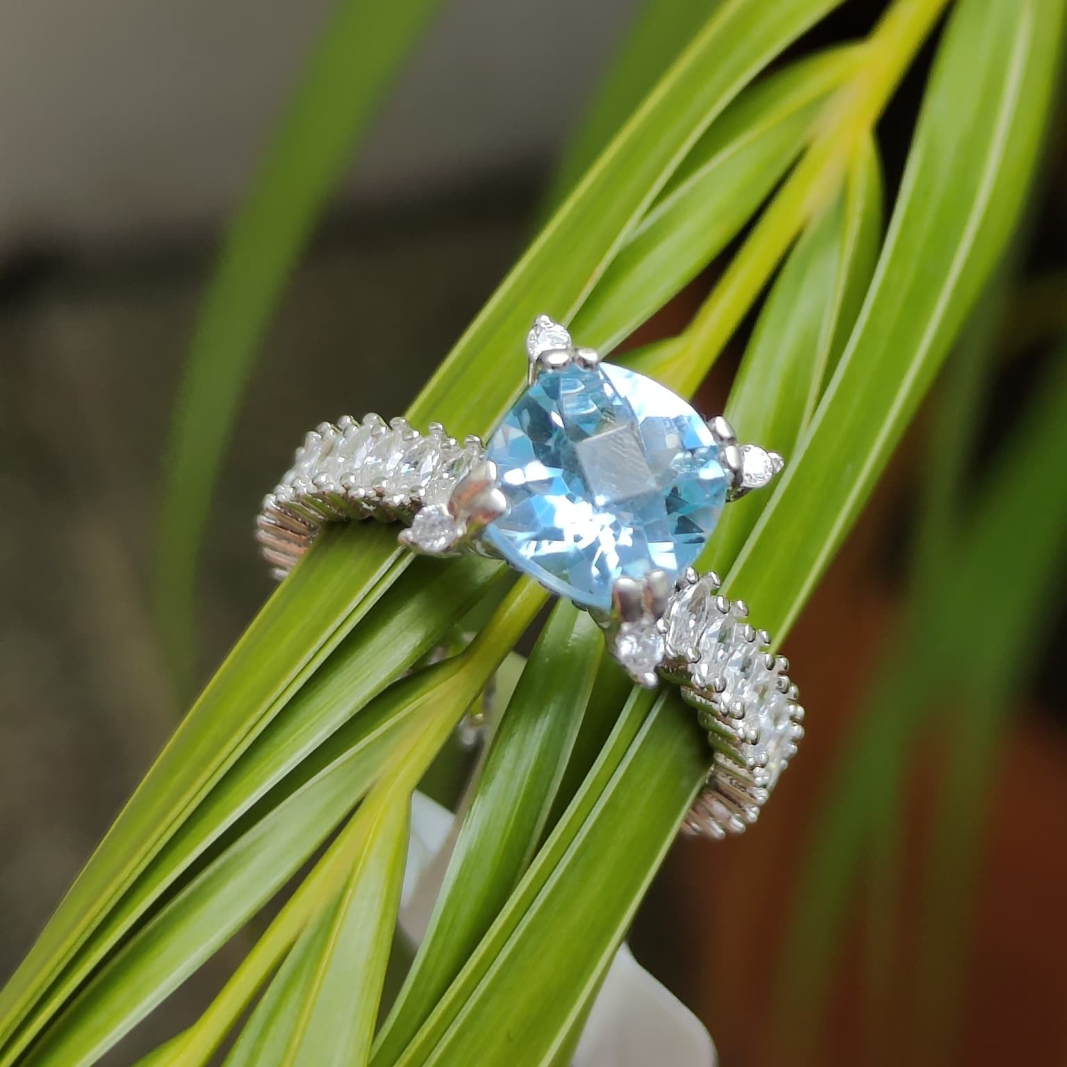 Shiza Gems cushion-cut sky blue topaz ring with marquise accent stones in 925 silver.