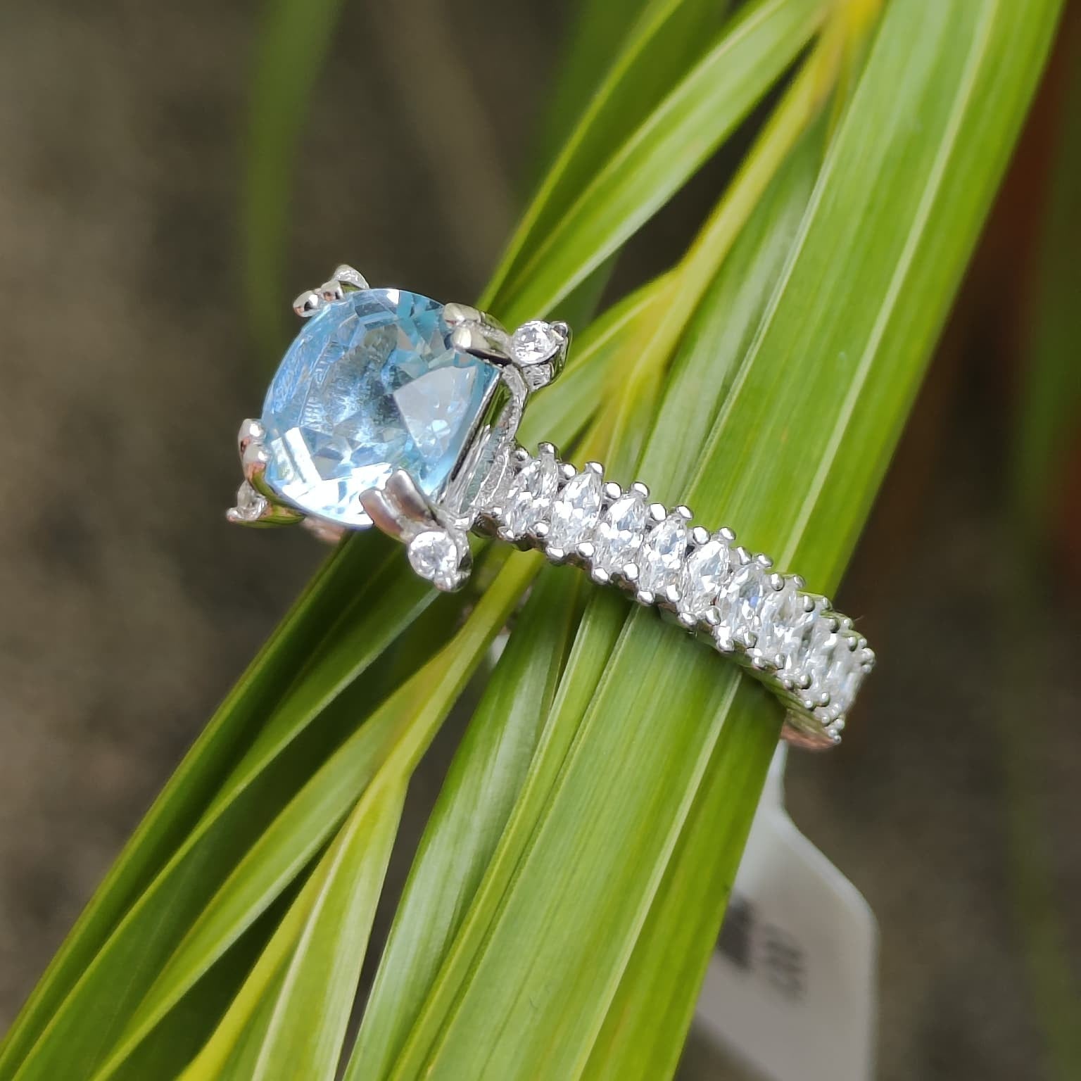 Shiza Gems Cushion-cut sky blue topaz ring with marquise accent band in 925 silver.