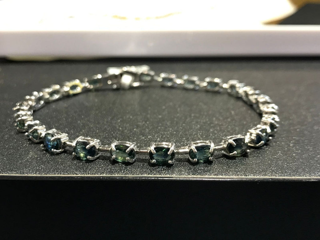 Shiza Gems oval teal sapphire and cubic zirconia tennis bracelet in sterling silver.