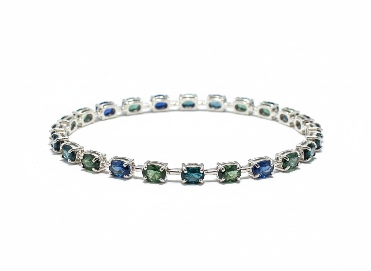 Shiza Gems oval teal sapphire and cubic zirconia tennis bracelet in sterling silver.