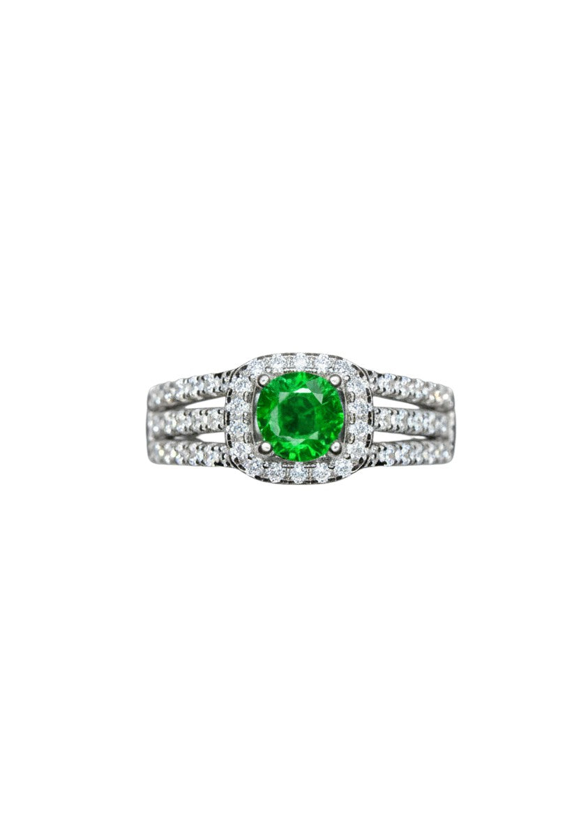 Shiza Gems Tsavorite silver ring with a central green gemstone surrounded by a halo of small diamonds.